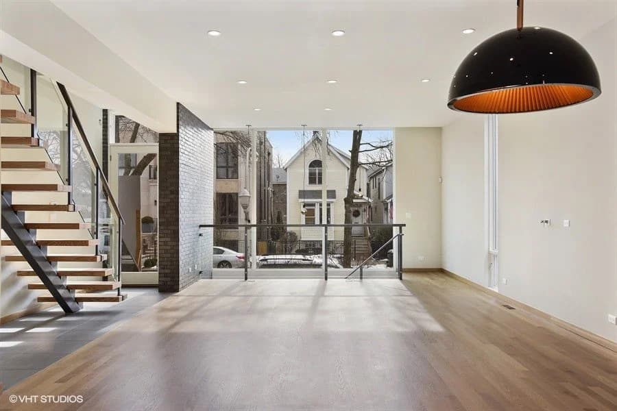 Modern open-plan interior with floating staircase, large windows, and white oak floors — 1756 W. Wabansia, Wicker Park